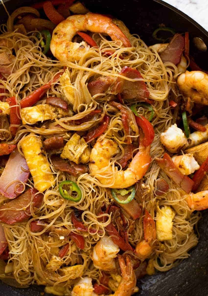 Singapore Noodles in a wok, fresh off the stove, ready to be served.