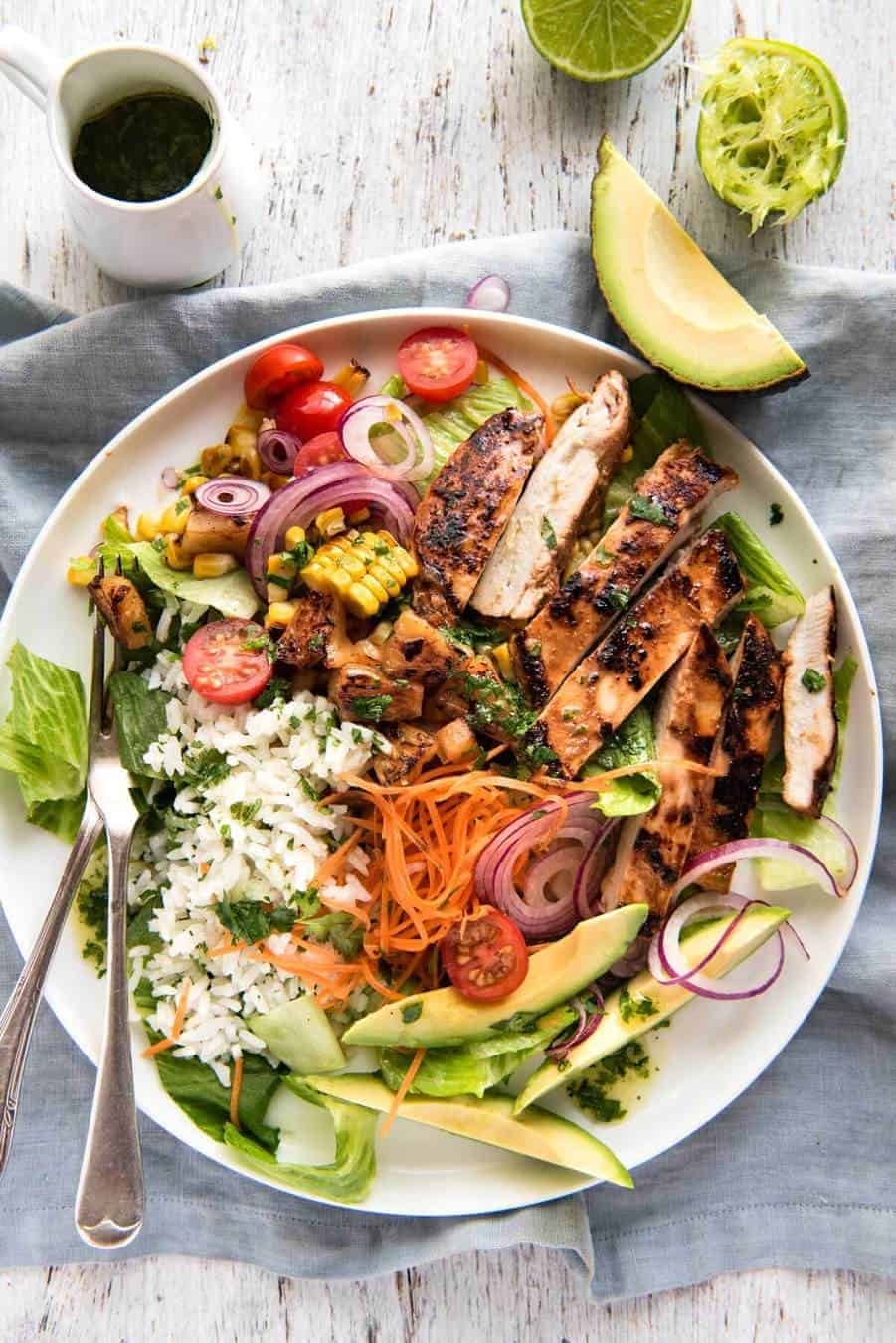 A salad with chicken marinated in pineapple juice, coconut milk & spices and a beautiful cilantro (coriander) lime dressing. The flavours of Hawaii - in a salad! staging.recipetineats.com