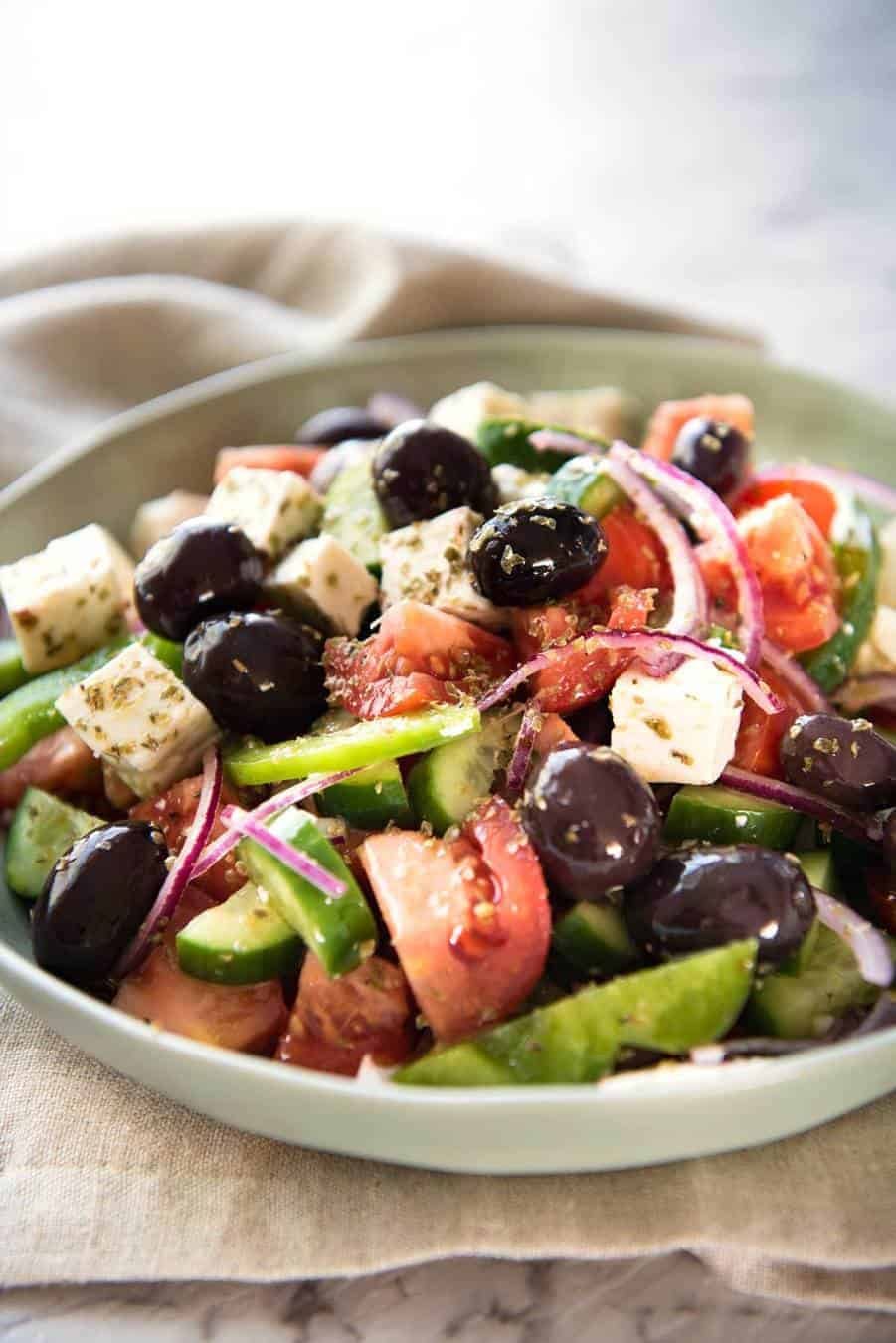 A classic Greek Salad with plump olives and a beautiful homemade Greek Salad Dressing. staging.recipetineats.com