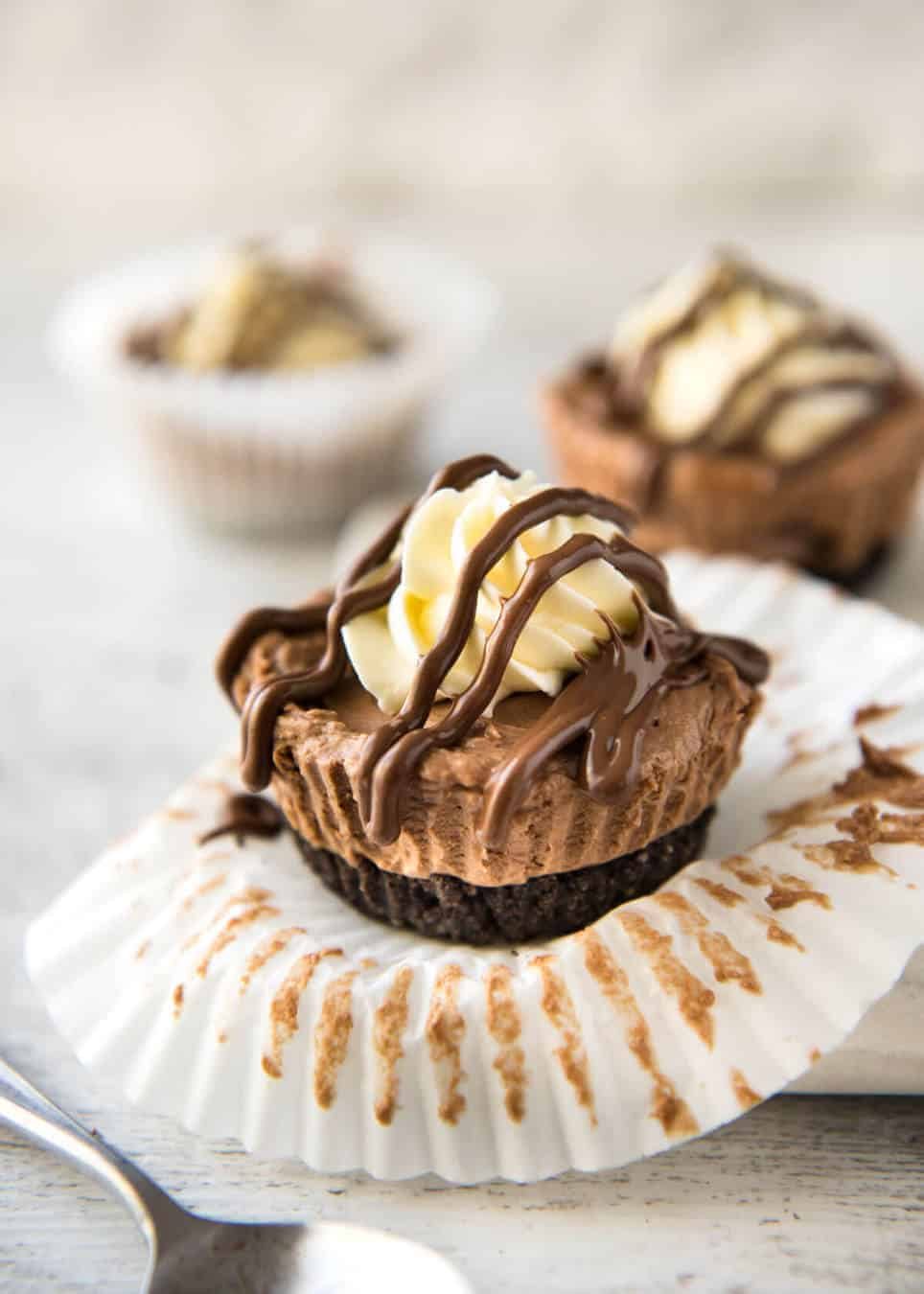 No Bake Nutella Cheesecake - Mini ones made in a muffin tin! A biscuit base and light mousse-like Nutella flavoured cheesecake. Easy to make and completely irresistible! staging.recipetineats.com