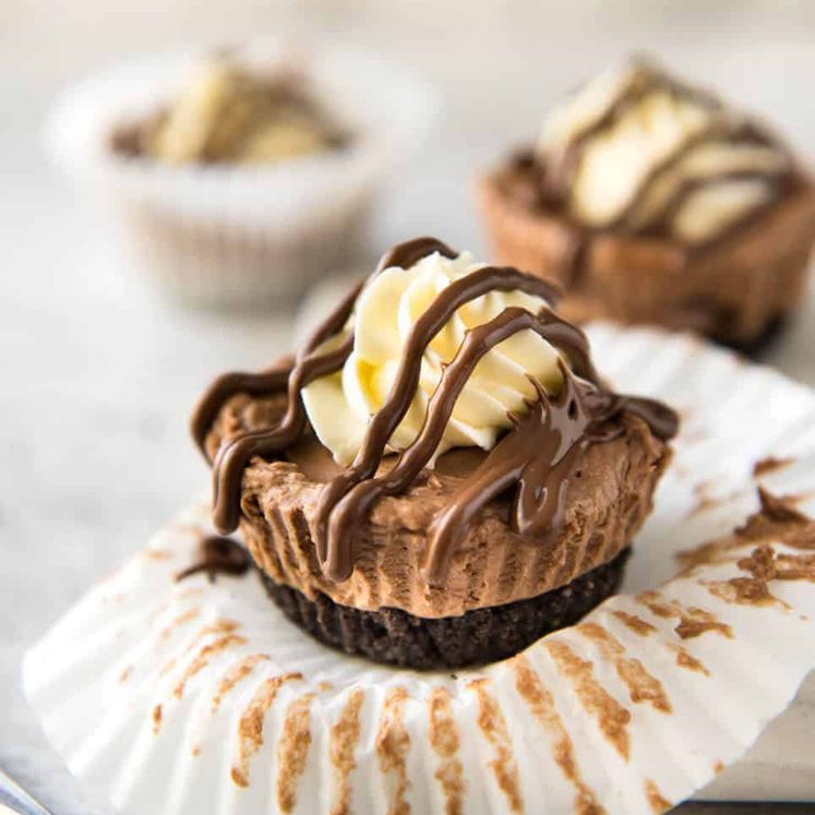 No Bake Nutella Cheesecake - Mini ones made in a muffin tin! A biscuit base and light mousse-like Nutella flavoured cheesecake. Easy to make and completely irresistible! staging.recipetineats.com