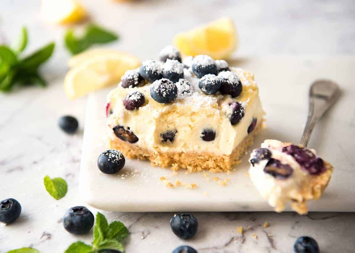 These Blueberry Cheesecake Bars are light yet creamy and luscious. Filled with soft blueberries, this is a baked cheesecake that's so easy to make! staging.recipetineats.com