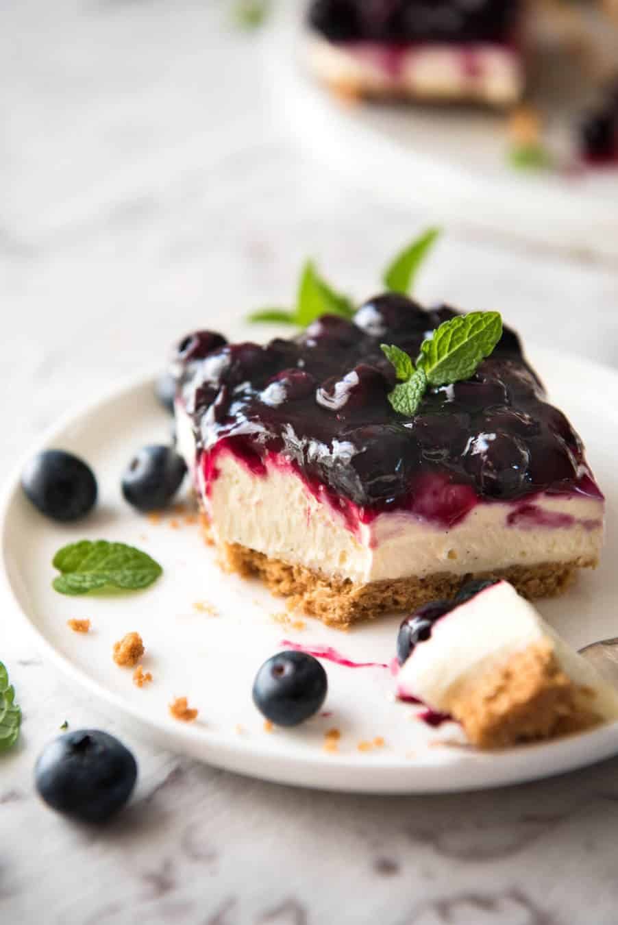 Easy and fast No Bake Blueberry Cheesecake Bars - creamy cheesecake with a gorgeous fresh blueberry sauce topping! staging.recipetineats.com