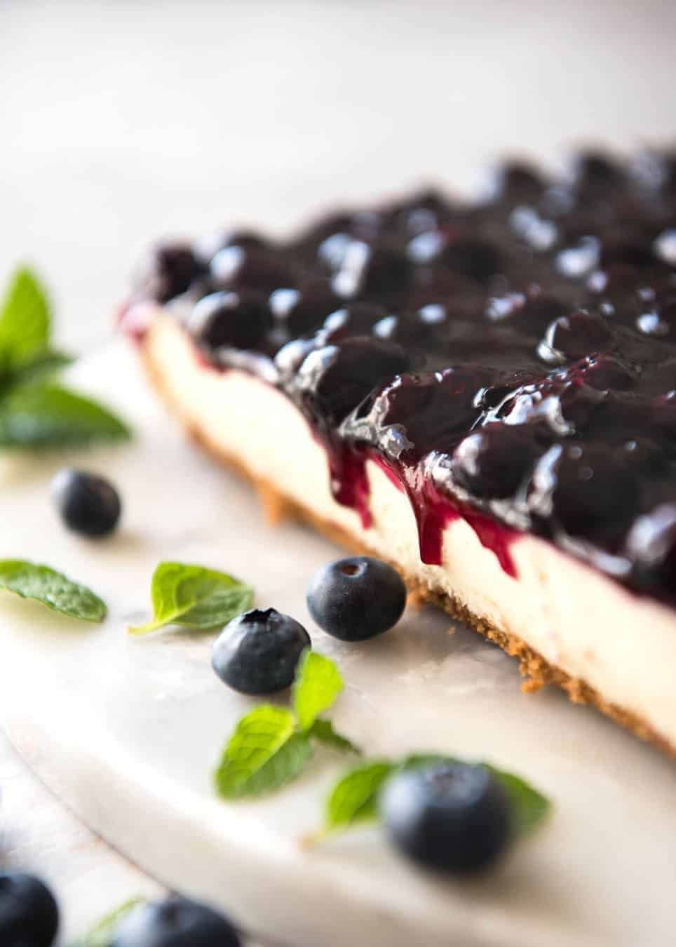 Easy and fast No Bake Blueberry Cheesecake Bars - creamy cheesecake with a gorgeous fresh blueberry sauce topping! staging.recipetineats.com
