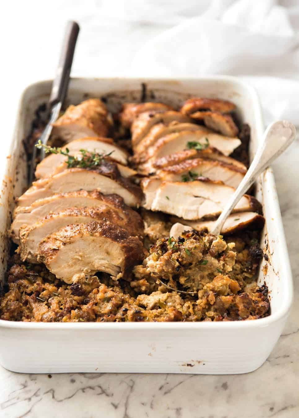 This Cajun dry brined turkey breast is baked in the same roasting pan as the Dressing / Stuffing so it's extra juicy and moist! A chef recipe, this Cajun Baked Turkey Breast with Dressing is easy and spectacular. EPIC ONE PAN COOKING for a Thanksgiving turkey! staging.recipetineats.com