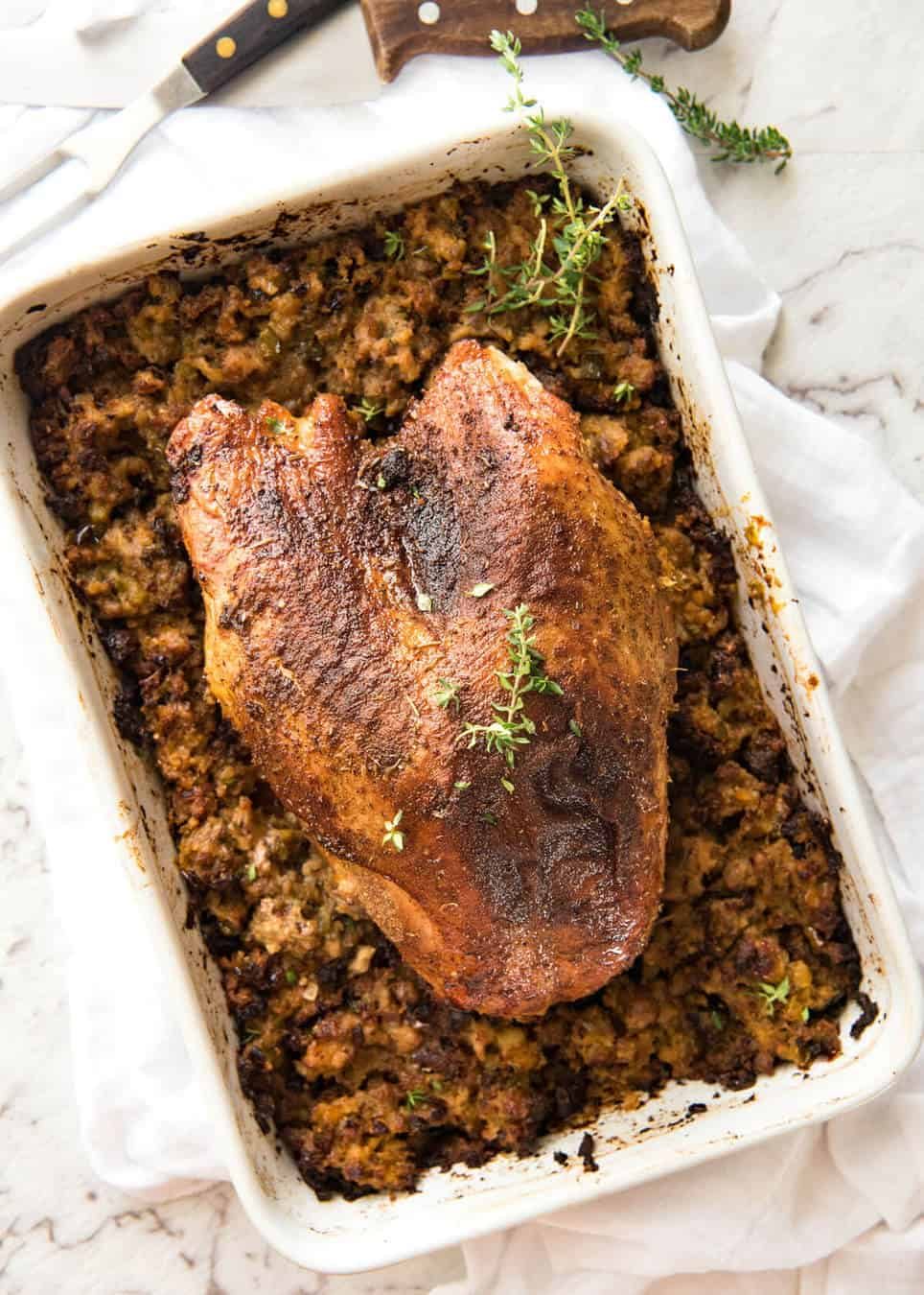 This Cajun dry brined turkey breast is baked in the same roasting pan as the Dressing / Stuffing so it's extra juicy and moist! A chef recipe, this Cajun Baked Turkey Breast with Dressing is easy and spectacular. EPIC ONE PAN COOKING for a Thanksgiving turkey! staging.recipetineats.com
