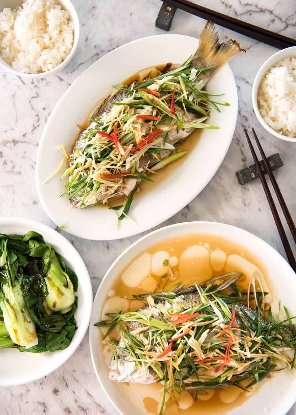 A Chinese Steamed Fish topped with Ginger and Shallots and seasonings, with hot oil poured over it to create a dramatic sizzle and an amazing sauce. So simple, yet so utterly delicious. Steam OR bake the fish! staging.recipetineats.com