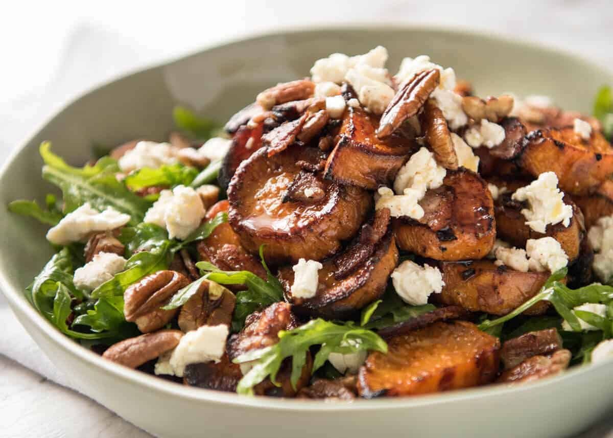 Roasted Sweet Potato Salad - with arugula/rocket, pecans, goats cheese or feta, a sprinkle of bacon and a beautiful Honey Lemon dressing. staging.recipetineats.com