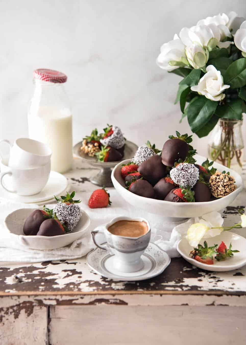 Table laid with Chocolate Covered Strawberries, coffee and milk jar.