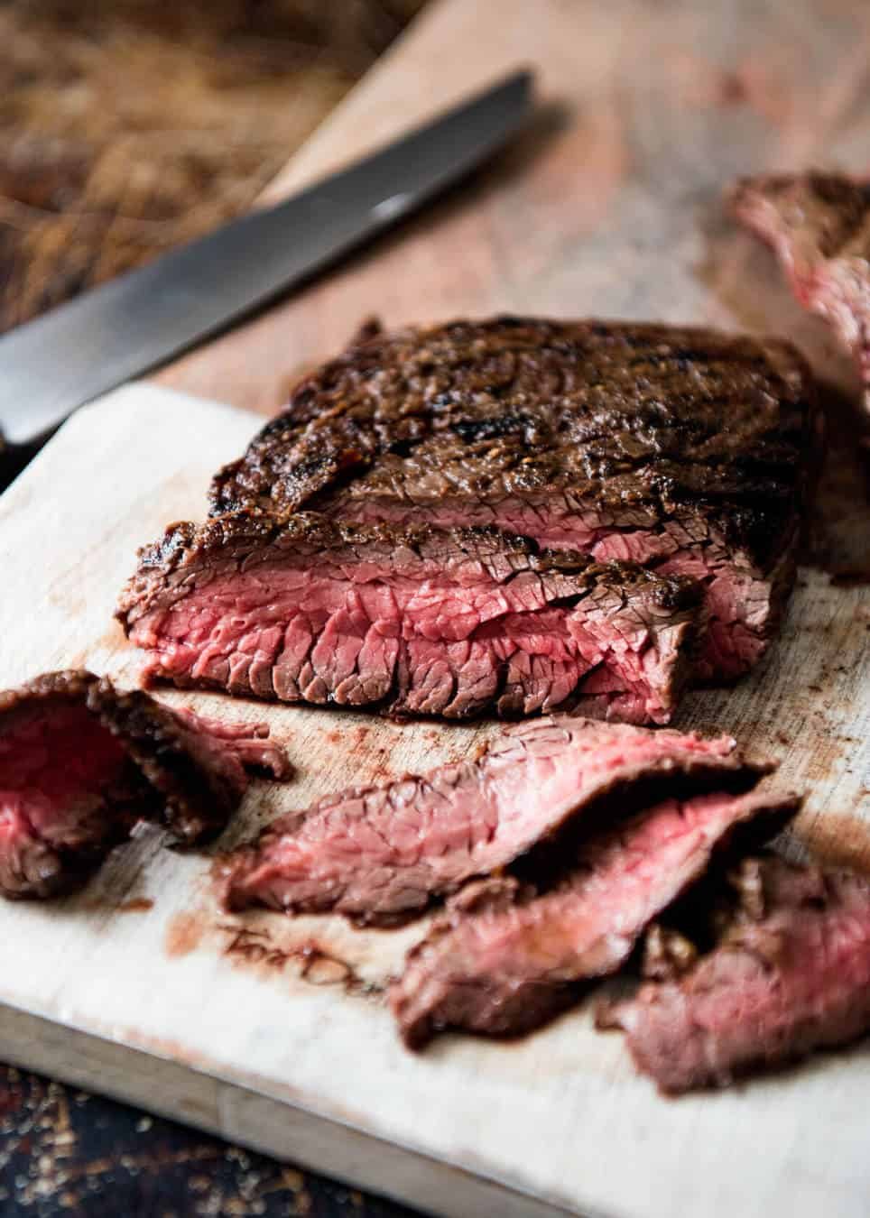 A juicy Steak Sandwich loaded with tender slices of steak, caramelised onion, garlic aioli, lettuce, tomato and mustard. staging.recipetineats.com
