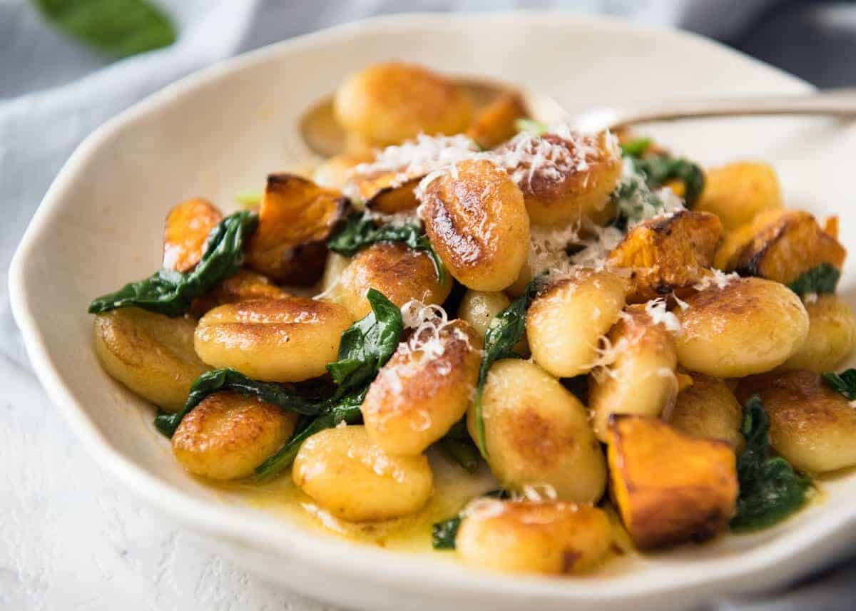 Pan Fried Gnocchi with Pumpkin and Spinach - Golden crispy on the outside, soft on the inside, with a butter sage sauce, roasted pumpkin and spinach. staging.recipetineats.com