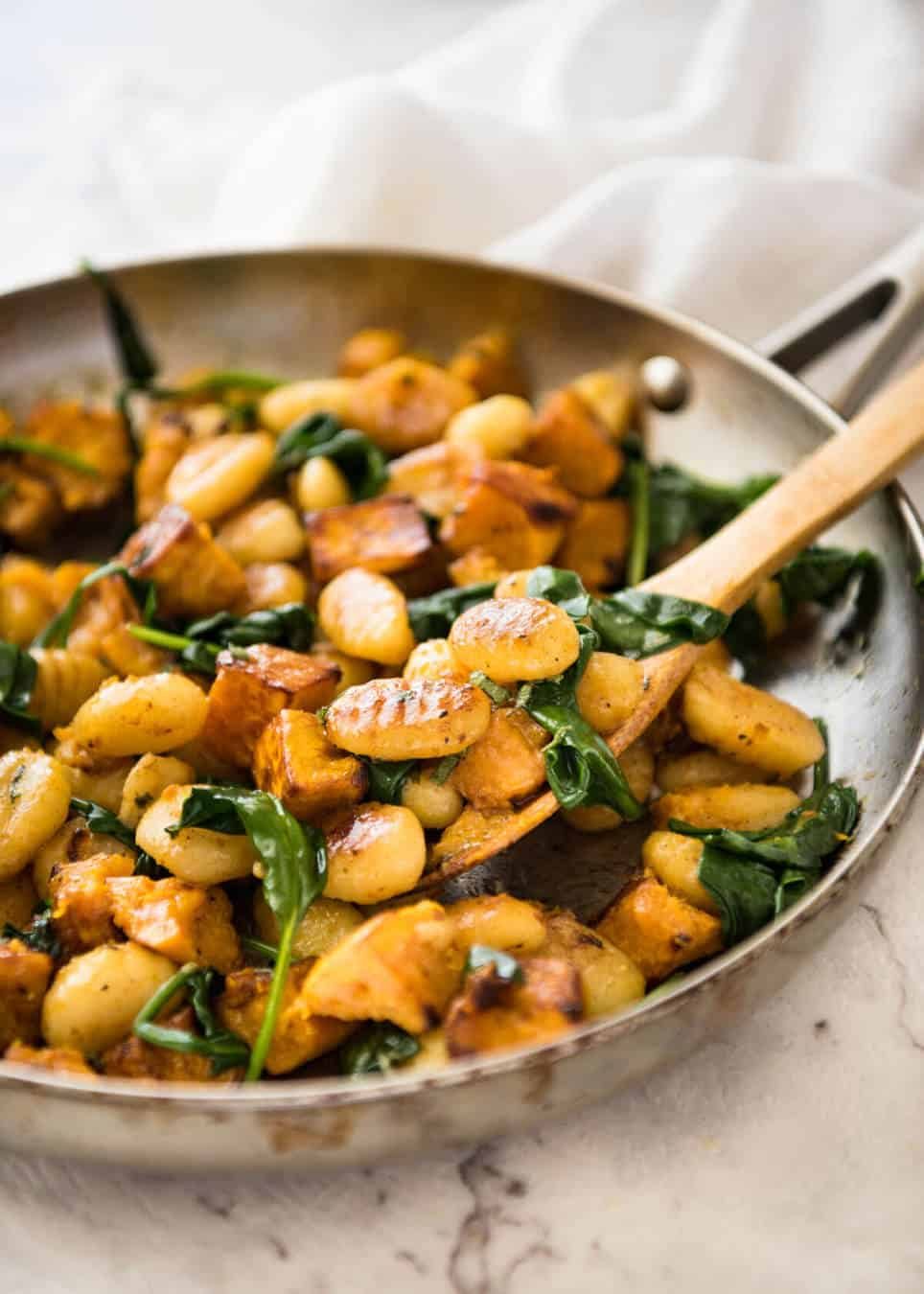 Pan Fried Gnocchi with Pumpkin and Spinach - Golden crispy on the outside, soft on the inside, with a butter sage sauce, roasted pumpkin and spinach. staging.recipetineats.com