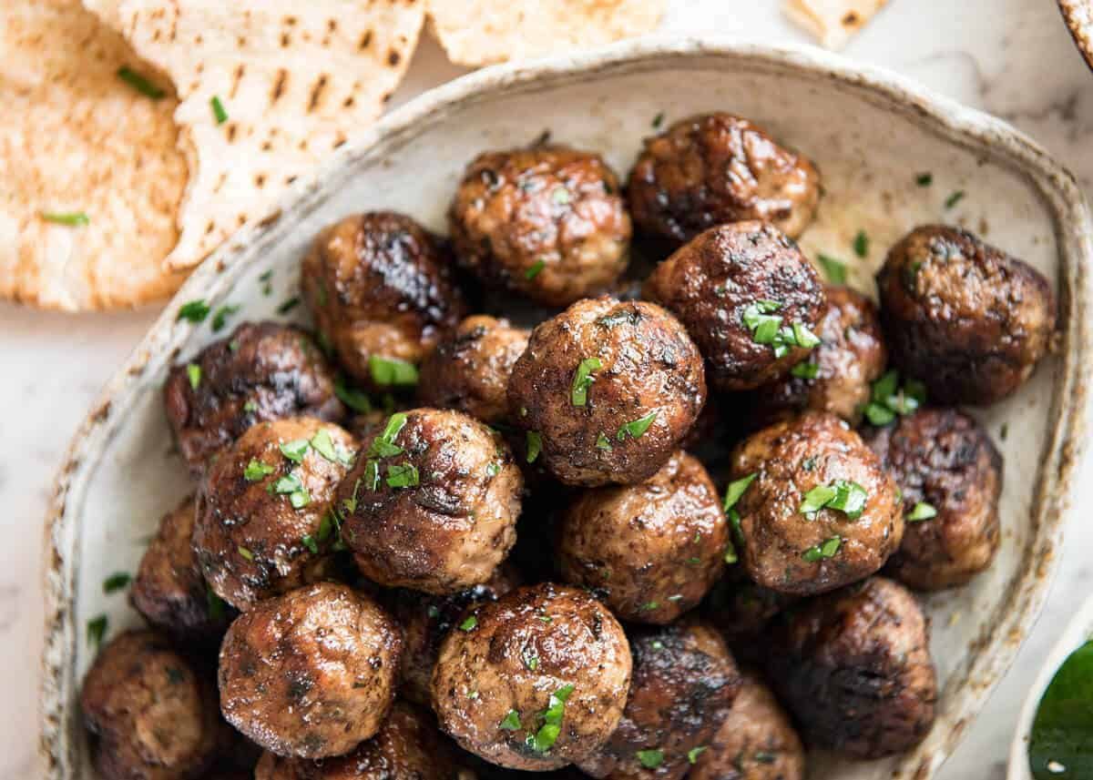Soft, juicy, beautifully flavoured GREEK MEATBALLS! Serve as an appetiser with tzatziki, main with Greek Salad or make wraps! staging.recipetineats.com