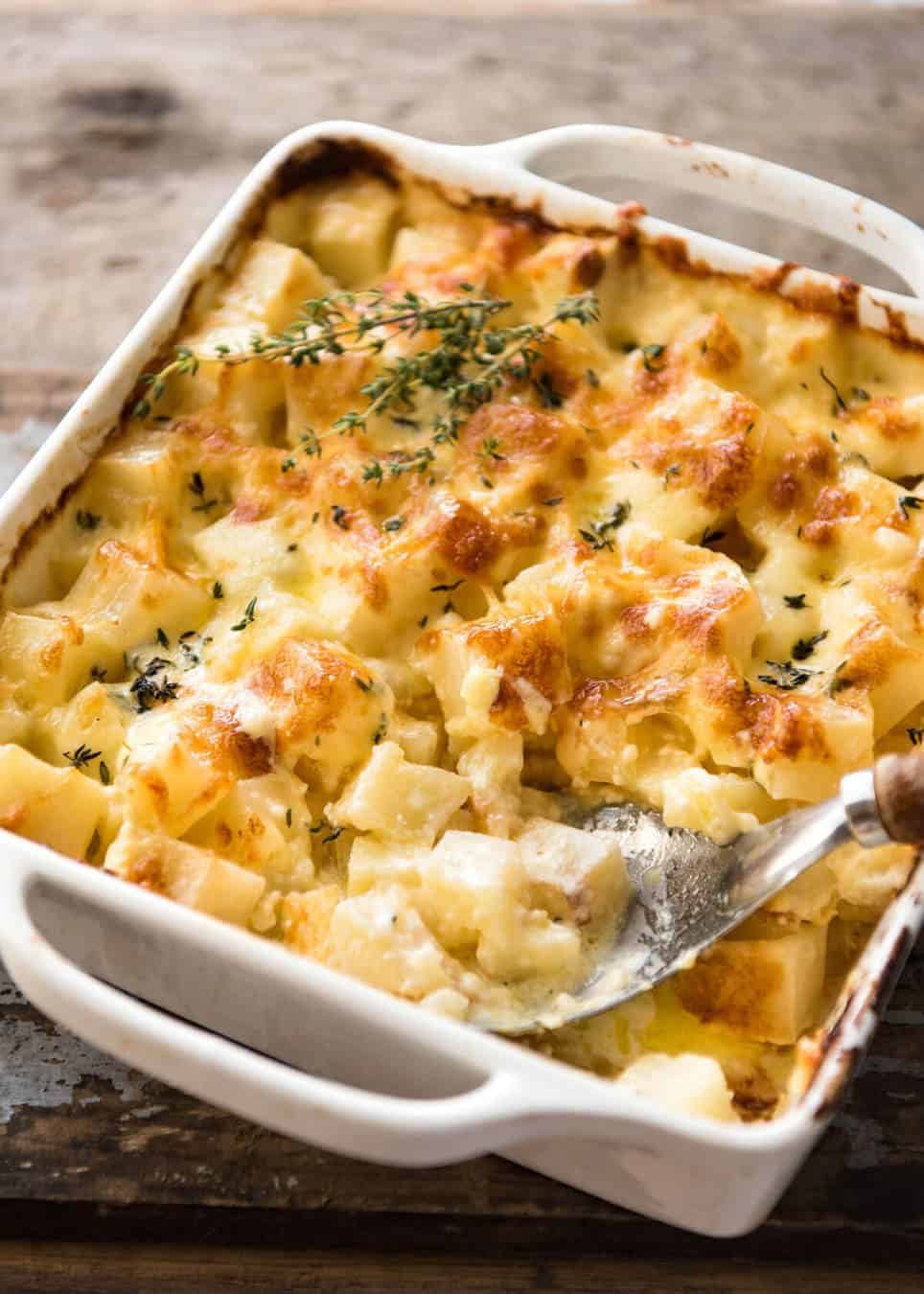 A faster, cheesier, creamier alternative to Scalloped Potatoes / Potato Gratin, this Easy Creamy Cheesy Potato Bake is made with cubed potatoes cooked in a cream and cheese sauce. staging.recipetineats.com