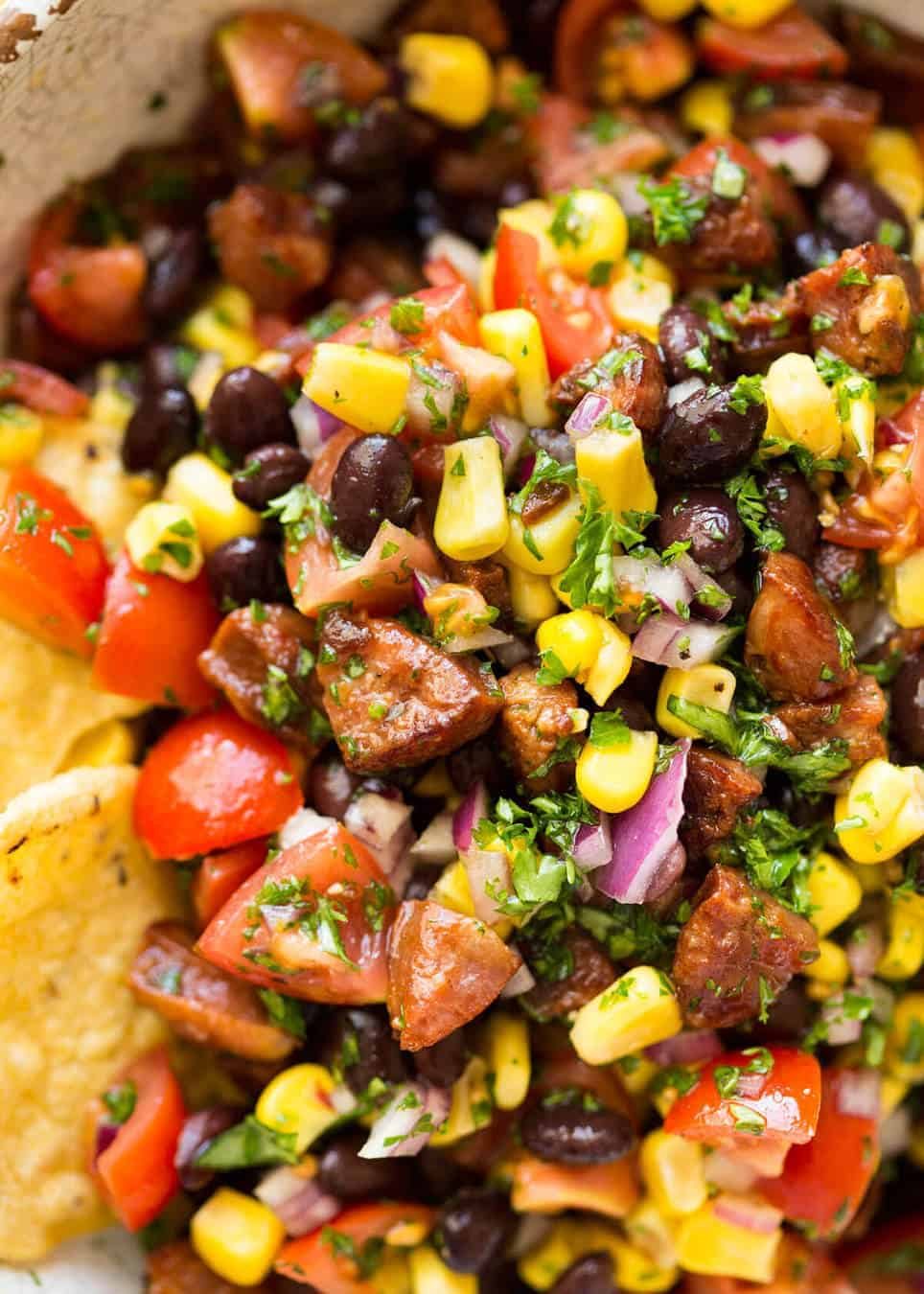 I call this a PIG OUT Salsa. Sensible people would call it an Chorizo, Black Bean and Corn Salsa. :) staging.recipetineats.com