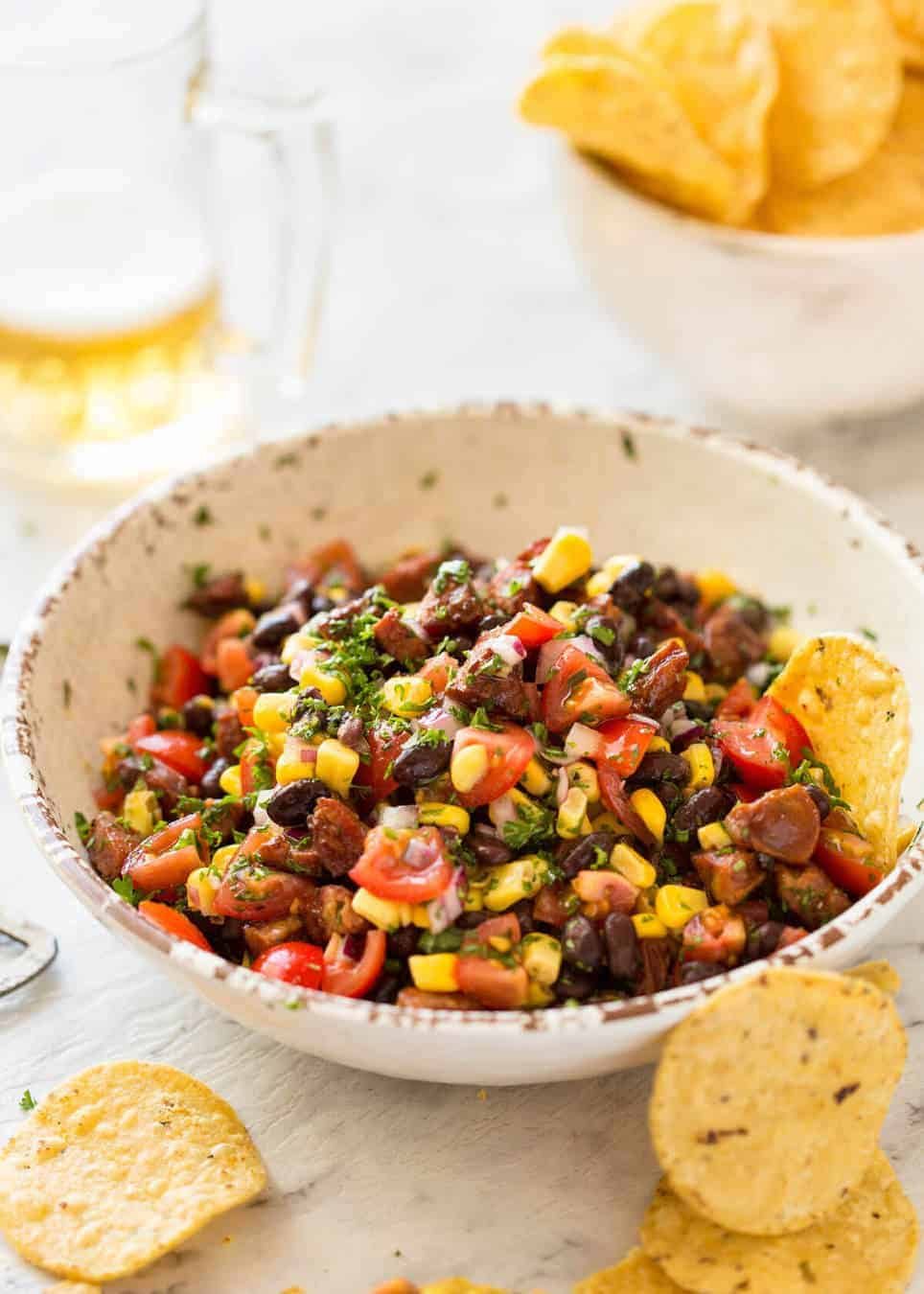 I call this a PIG OUT Salsa. Sensible people would call it an Chorizo, Black Bean and Corn Salsa. :) staging.recipetineats.com