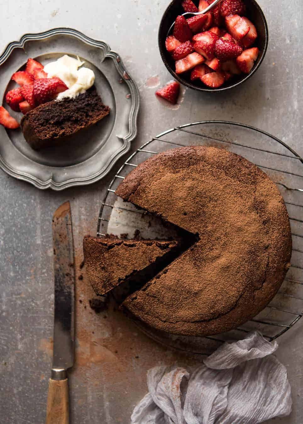 A simple Flourless Chocolate Cake made with almond meal / almond flour. Moist inside, with a thin crackly brownie-like surface. A stunning, very quick cake to make! staging.recipetineats.com
