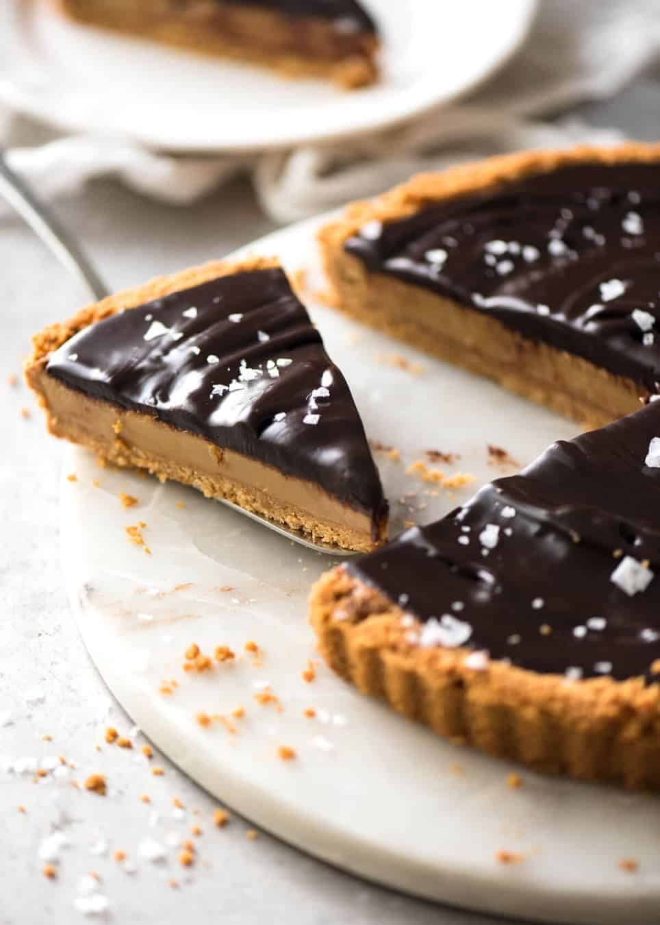 A sinfully decadent Salted Caramel Tart with a creamy soft salted caramel filling topped with luxurious chocolate ganache. Just SIX ingredients! staging.recipetineats.com