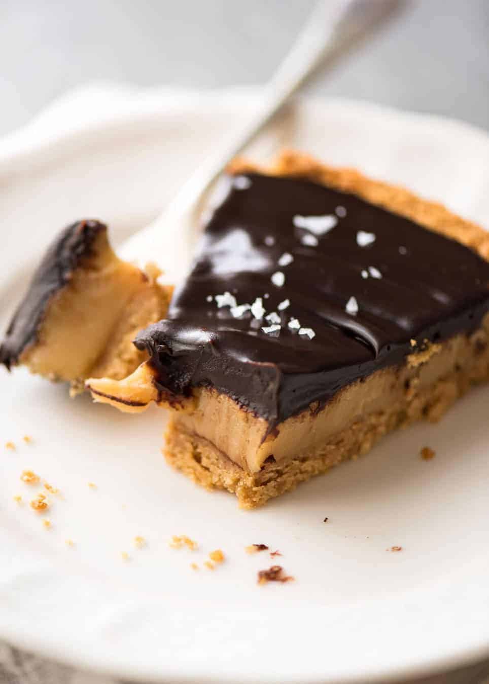 A sinfully decadent Salted Caramel Tart with a creamy soft salted caramel filling topped with luxurious chocolate ganache. Just SIX ingredients! staging.recipetineats.com
