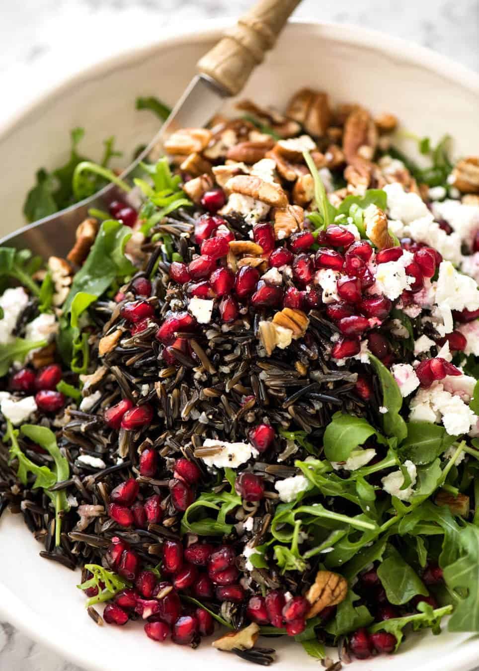 This Wild Rice Salad is a salad for celebrations! Stellar flavour combination - wild rice, pomegranate, pecans, rocket / arugula, green onions, cranberries and feta. staging.recipetineats.com
