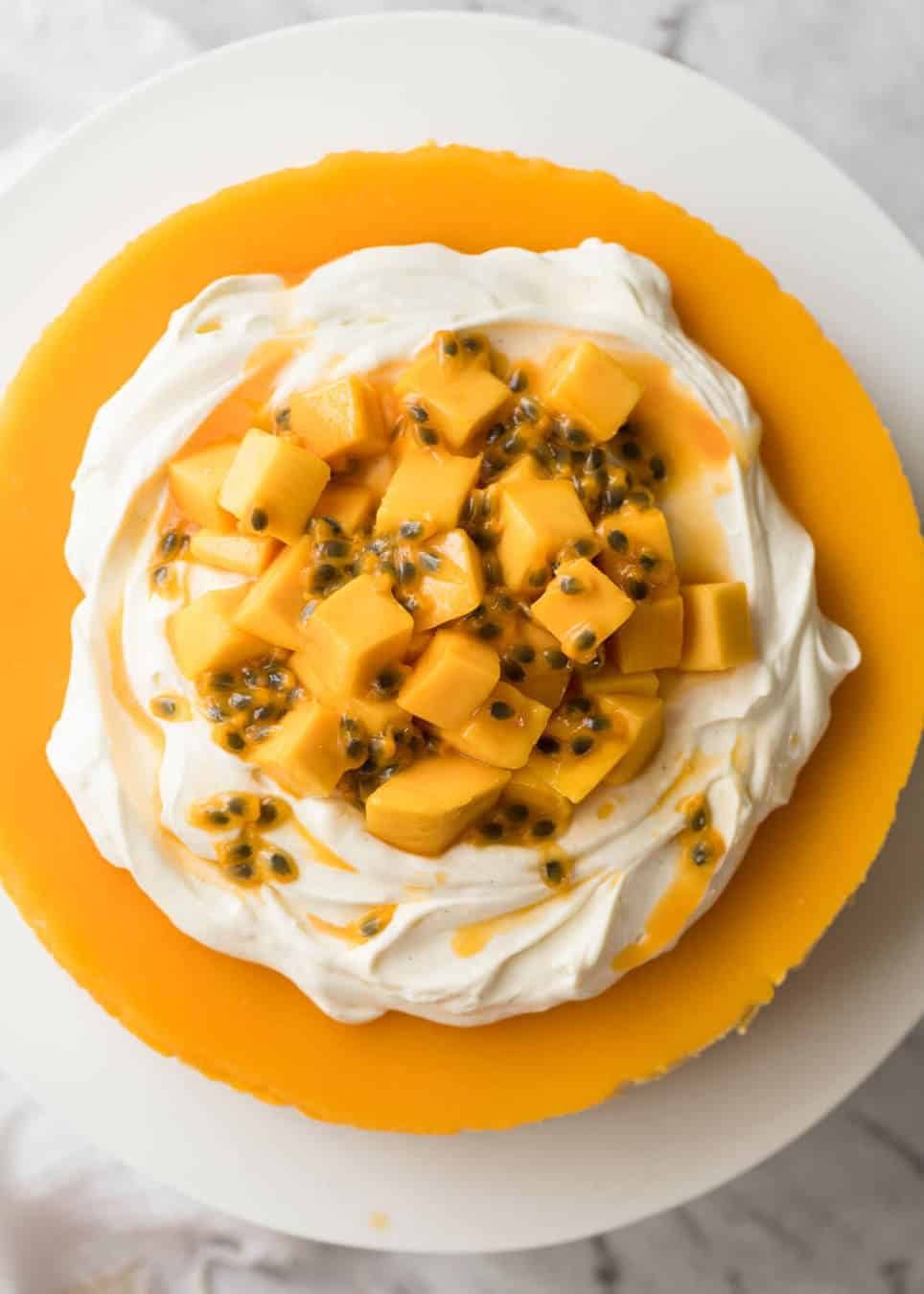 Toppings to decorate mango cheesecake - cream, passionfruit and mangoes. staging.recipetineats.com