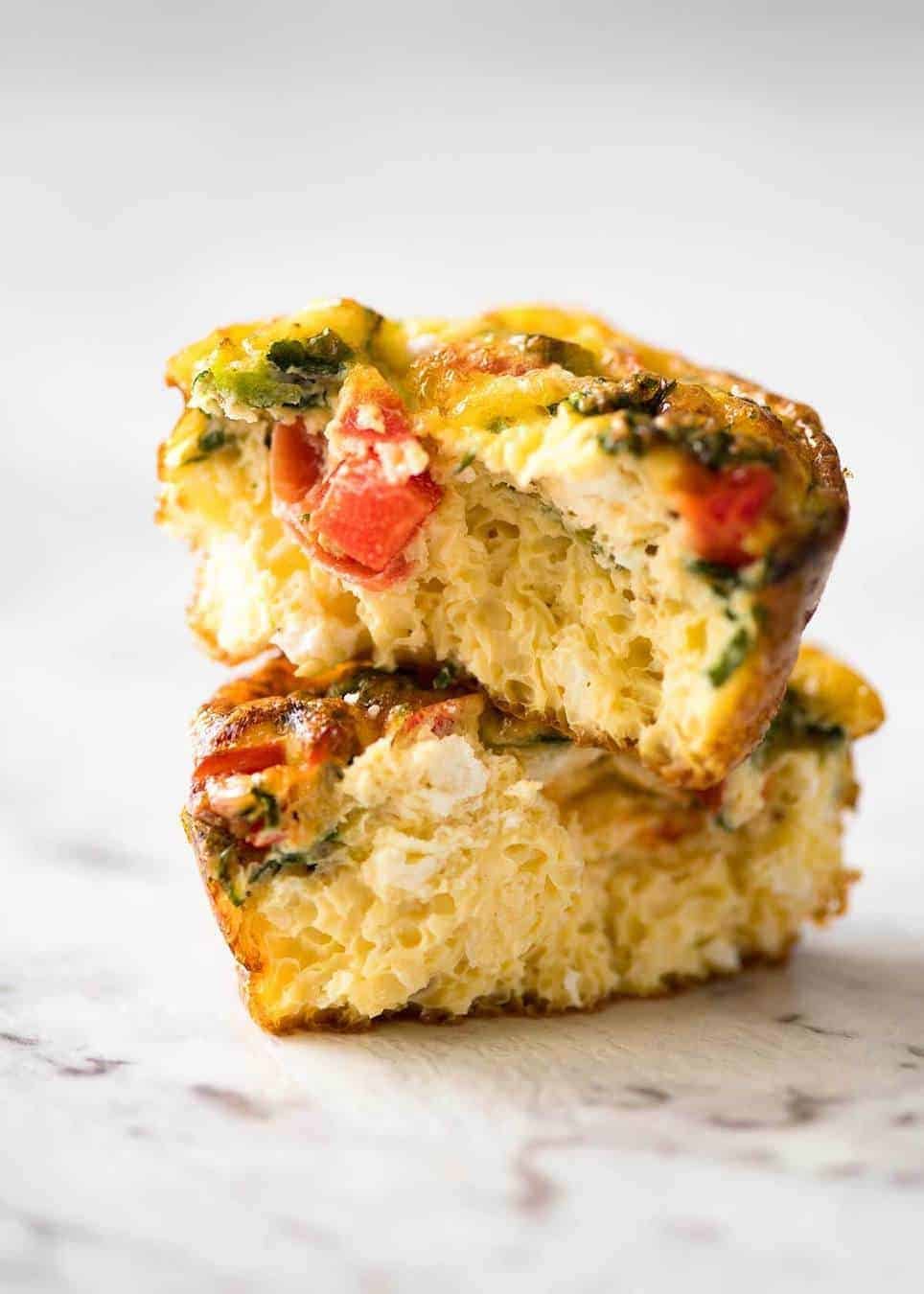 Healthy doesn't have to be bland! These Healthy Egg Muffins are a great grab & go breakfast option. Egg, spinach, feta, cherry tomatoes and bell peppers/capsicum. staging.recipetineats.com