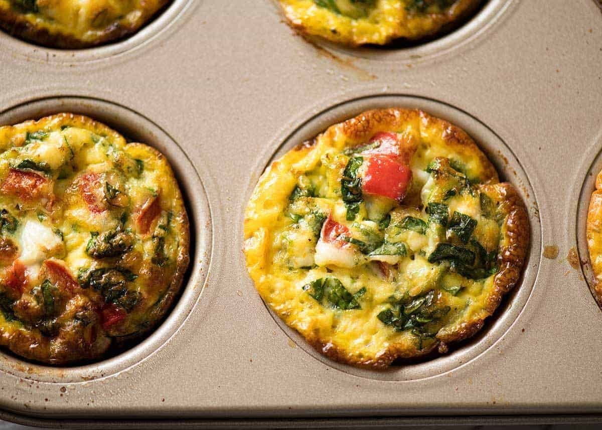 Healthy doesn't have to be bland! These Healthy Egg Muffins are a great grab & go breakfast option. Egg, spinach, feta, cherry tomatoes and bell peppers/capsicum. staging.recipetineats.com
