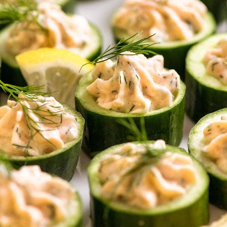 Close up of Cucumber Canap&eacute;s topped with smoked salmon mousse garnished with dill