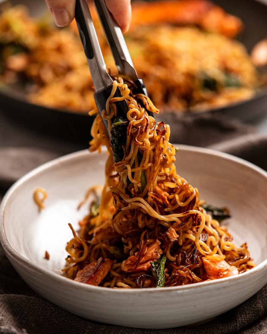 Serving Teriyaki Salmon Noodles into a bowl